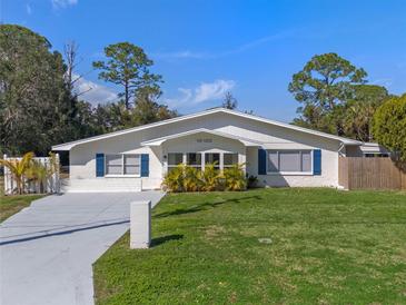 Charming single-story home featuring a well-maintained lawn and blue shutters at 1300 Conrad Dr, New Smyrna Beach, FL 32168