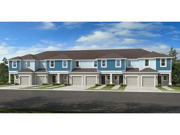 Beautiful new townhomes with attached garages, manicured lawns, and professionally designed exterior color palettes at 2512 Penguin Blvd, Davenport, FL 33837
