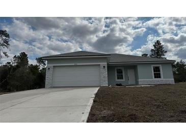 Charming one-story home with attached garage and a freshly poured concrete driveway at 2942 Sw 162Nd St, Ocala, FL 34473