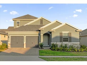 Charming two-story home with a two-car garage and beautifully landscaped front yard at 4472 Lions Gate Ave, Clermont, FL 34711