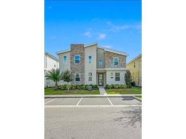 Inviting two-story townhome featuring stone accents and a well-maintained front yard landscape at 4532 Target Blvd, Kissimmee, FL 34746