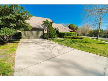Lovely single-story home featuring an attached two-car garage, attractive landscaping, and a concrete driveway at 5016 Fawn Ridge Rd, Orlando, FL 32819