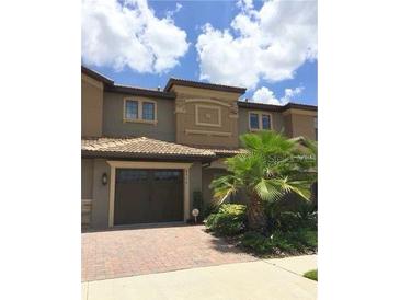 Charming two-story townhome with a well-manicured lawn and a convenient attached garage, with great curb appeal at 8950 Azalea Sands Ln # 8950, Champions Gate, FL 33896