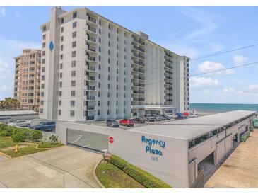 Regency Plaza condo building exterior showing parking and nearby ocean at 1415 Ocean Shore Blvd # 704, Ormond Beach, FL 32176