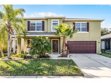 Charming two-story home with lush landscaping, beautiful palms, and a two car garage at 2564 Bullion Loop, Sanford, FL 32771