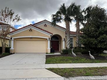 Charming single-story home with a terra cotta tile roof, well-manicured lawn, and a two-car garage at 5356 Oakbourne Ave, Davenport, FL 33837