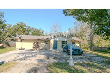 Charming single-story home featuring a blue front door and a spacious driveway at 1041 Vihlen Rd, Sanford, FL 32771