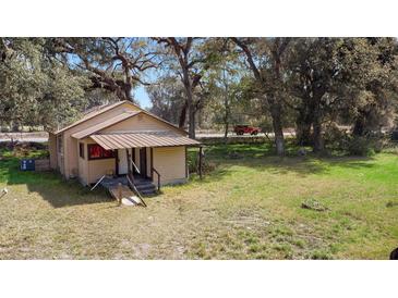 Charming vintage house nestled in a yard with mature trees at 1213 Cr 652, Bushnell, FL 33513