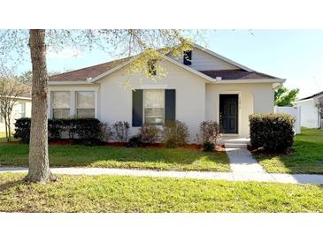 Charming single Gathering home featuring well-maintained front yard landscaping and welcoming entrance at 13812 Cepheus Dr, Orlando, FL 32828