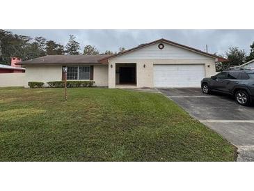 Single story home featuring a well maintained front lawn and a two car garage at 2903 Clear Way, Orlando, FL 32805