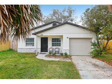 Charming single Gathering home with a manicured front yard, walkway and attached garage at 304 Dover St, Orlando, FL 32811