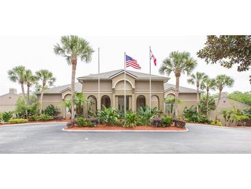 Welcoming community clubhouse featuring lush landscaping and prominent flag displays at 385 Wymore Rd # 200, Altamonte Springs, FL 32714