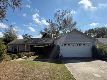 Charming single-story home with well-maintained lawn and attached two-car garage at 6725 Sawmill Blvd, Ocoee, FL 34761