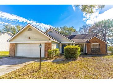 Charming single-Gathering home featuring brick and siding accents, attached garage, and landscaped front yard at 762 Lake Como Dr, Lake Mary, FL 32746