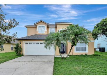 Charming two-story home boasts a manicured lawn and a spacious two-car garage, perfect for a growing Gathering at 7916 Golden Pond Cir, Kissimmee, FL 34747