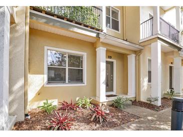 Inviting home exterior with well-manicured landscaping and a charming entrance with a balcony above at 11 W Harding St # D, Orlando, FL 32806