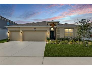 Charming single-story home featuring a well-manicured lawn, and a 3-car garage at 1908 Perch Hammock Loop, Groveland, FL 34736