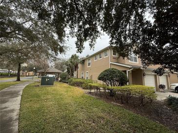 A charming home with well-maintained landscaping and a two-car garage at 2511 Metro Sevilla Dr # 101, Orlando, FL 32835