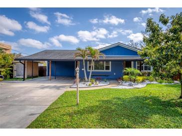 Charming blue home featuring a landscaped front yard, carport, and inviting curb appeal at 328 Lake Fair Ln, Winter Park, FL 32789