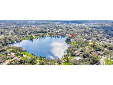 Expansive aerial view of lakefront community with lush landscaping and sparkling lake at 632 Tranquil Oaks Ln, Oviedo, FL 32765