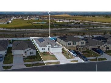 Beautiful aerial view of house showing the community and the exterior elevation with a well manicured lawn at 1934 Pond Pine Ct, Haines City, FL 33844