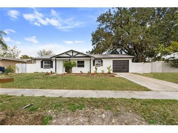 Charming single-story home featuring a well-maintained lawn, dark garage door, and welcoming curb appeal at 7331 Blue Jacket W Pl, Winter Park, FL 32792