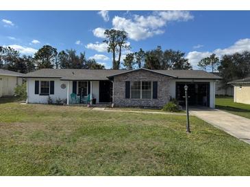 Charming single-story home featuring a brick facade accent and well-maintained lawn at 1024 W Embassy Dr, Deltona, FL 32725