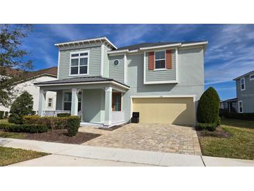Charming two-story home featuring a covered porch and a two-car garage with a beautifully landscaped front yard at 1731 Caribbean View Ter, Kissimmee, FL 34747