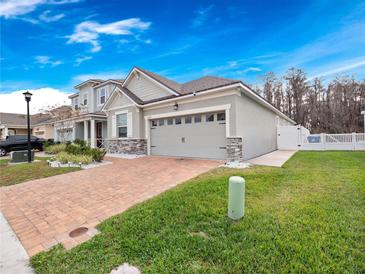 Charming single-Gathering home featuring a paved driveway and a well-manicured lawn at 2479 Empress Dr, Kissimmee, FL 34741