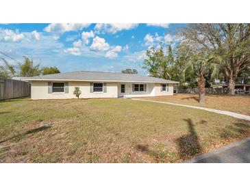 Single-story home with a light colored exterior and well-manicured lawn at 345 Overstreet Ave, Longwood, FL 32750