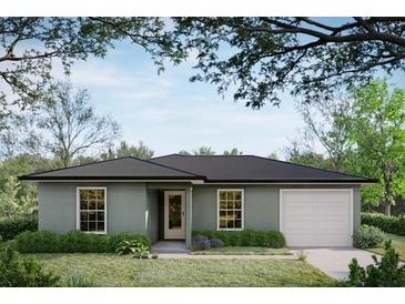 Charming single-story home featuring a well-maintained lawn and a classic architectural design at 38934 Merrell Ave, Umatilla, FL 32784