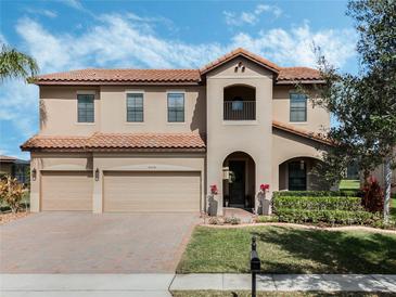 Charming two-story home with three-car garage, tile roof and manicured lawn at 4903 Eastlake Vista Dr, St Cloud, FL 34771