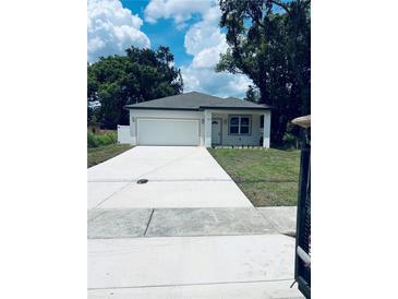 Charming single-story home with a spacious driveway and attached garage at 1015 25Th St, Orlando, FL 32805