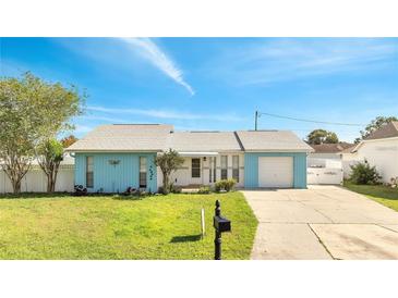 Charming single-story home featuring a well-manicured lawn and a driveway leading to an attached garage at 161 Laurel Way, Kissimmee, FL 34743