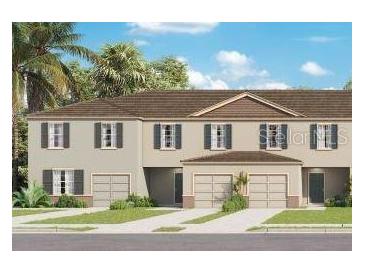 New home showcasing a charming, two-story townhome design, lush landscaping, and individual driveways, radiating curb appeal at 3380 Private Oak Dr, Apopka, FL 32703