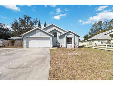 Charming single-story home featuring a two-car garage and well-maintained landscaping at 9307 Echo Run, Orlando, FL 32817