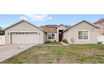 Charming single-story home with a two-car garage and well-maintained front lawn at 2537 Rock Pl, Poinciana, FL 34759