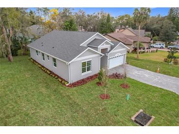 Well-manicured lawn and modern exterior highlight this charming one-story single Gathering home at 340 Bahia Cir, Longwood, FL 32750