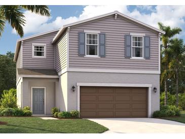 Charming two-story home with gray siding, blue shutters, and a two-car garage at 3507 Salvia Ct, Tavares, FL 32778