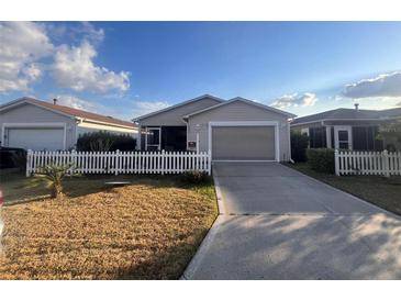 Charming single-story home featuring a neat front yard and a classic white picket fence at 2450 Southern Oak St, The Villages, FL 32162