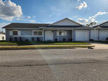 Charming single-story home with attached garage and well-manicured front lawn at 3112 Eleuthera Ln, Orlando, FL 32827