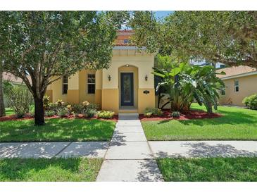 Inviting home featuring a well-manicured lawn, complemented by mature trees and vibrant landscaping at 3350 Pegaso Ave, New Smyrna Beach, FL 32168