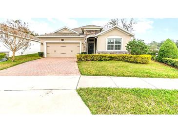 Charming single Gathering home with a two-car garage and a well-manicured lawn at 6097 Monterey Cypress Trl, Sanford, FL 32773