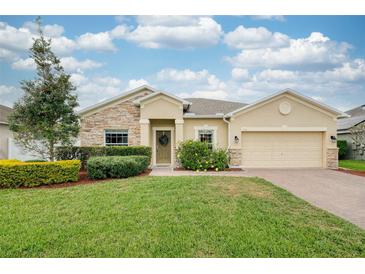 Charming single-story home with manicured lawn, stone accents, and a welcoming front entrance at 636 Bainbridge Loop, Winter Garden, FL 34787