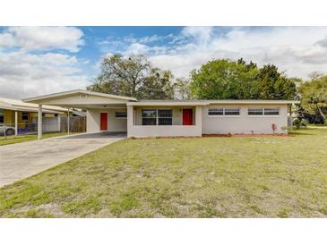 Charming single-story home with a well-maintained lawn and neutral-toned exterior at 812 Oleander St, New Smyrna Beach, FL 32168