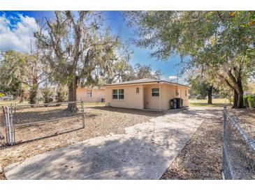 Cozy one-story home with a fenced yard and a concrete driveway, providing ample parking space at 203 North E Blvd, Davenport, FL 33837