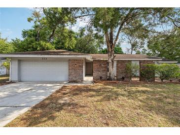 Charming single-story brick home with attached garage and mature trees in a well-maintained yard at 353 E Orange St, Altamonte Springs, FL 32701