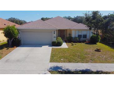 Charming single-story home boasts a well-manicured lawn, attached garage, and inviting curb appeal at 4175 Sw 46Th Ct, Ocala, FL 34474