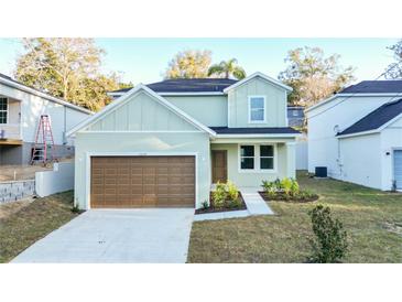 Charming two-story home with a brown garage door and a well-manicured lawn at 1039 Morningside Dr, Eustis, FL 32726