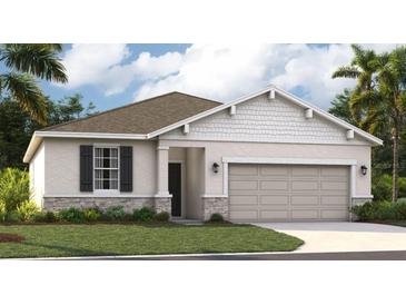 Charming single-story home with a two-car garage, stone accents, and beautifully landscaped front yard at 1130 Clay Blvd, Tavares, FL 32778